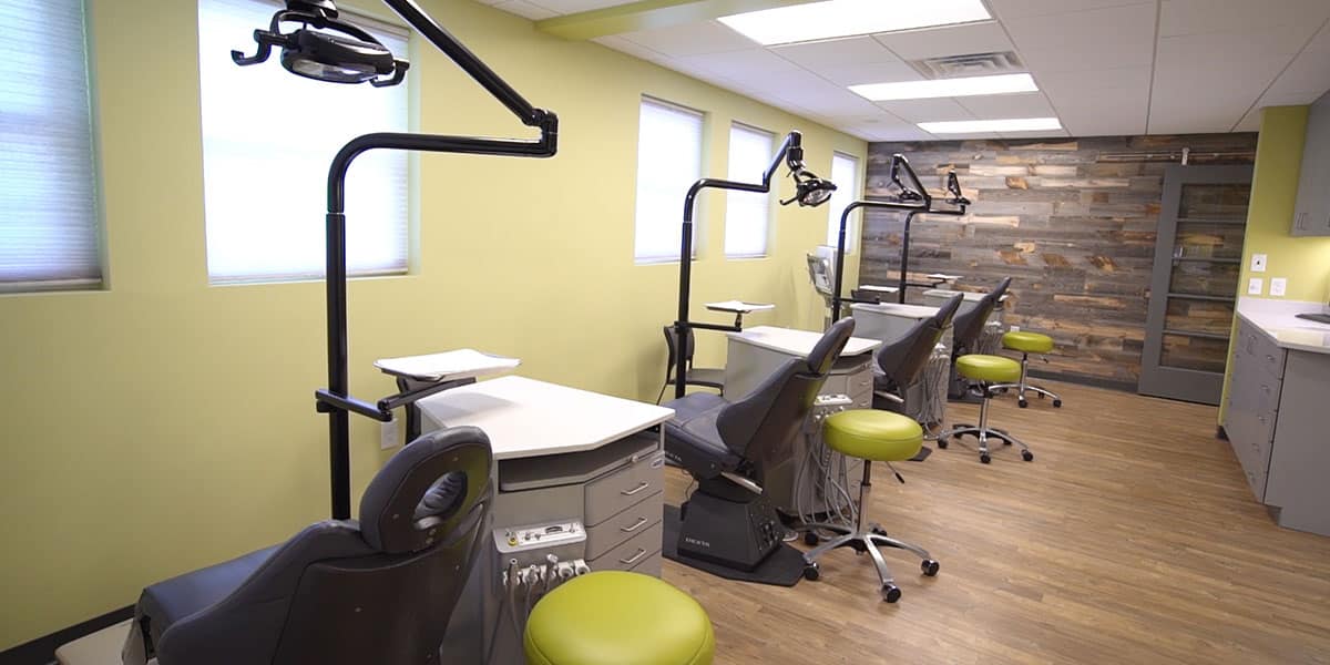 four exam chairs lined next to each other in an orthodontist office