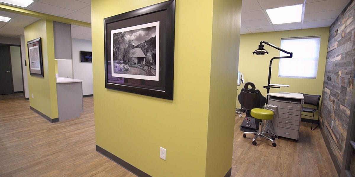 hallway with yellow walls and an orthodontic exam room