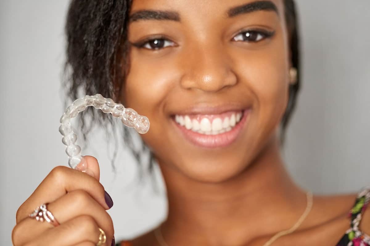 Teen Girl Holding Invisalign Aligner.jpg