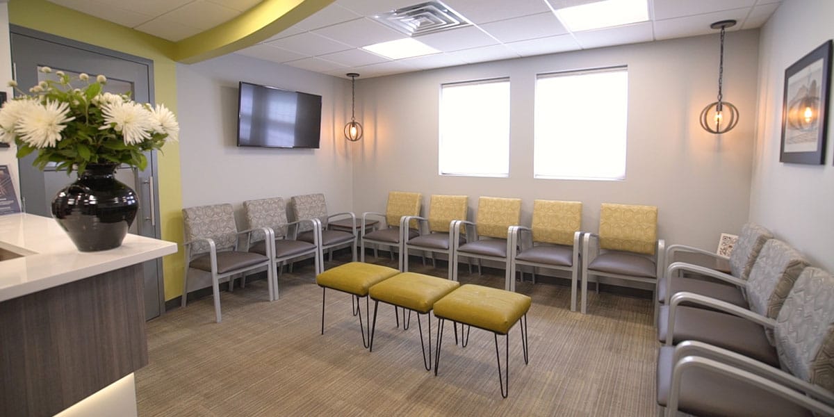 waiting room with yellow and grey chairs